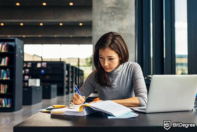 How to code for beginners: a girl learning from a book